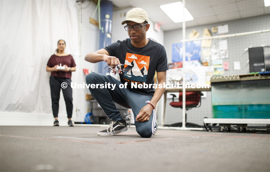 Nathan Simms is conducting drone research as part of Nebraska's inaugural FYRE program. Nathan, a freshman in Mechanical Engineering from Bellevue, NE, receives flight instruction to fly a small drone in the NIMBUS lab from Siya Kunde, Phd. student in Computer Science. The flying is part of the Foundational interaction Research with Drones research team under Professor Brittany Duncan. September 25, 2019. Photo by Craig Chandler / University Communication.