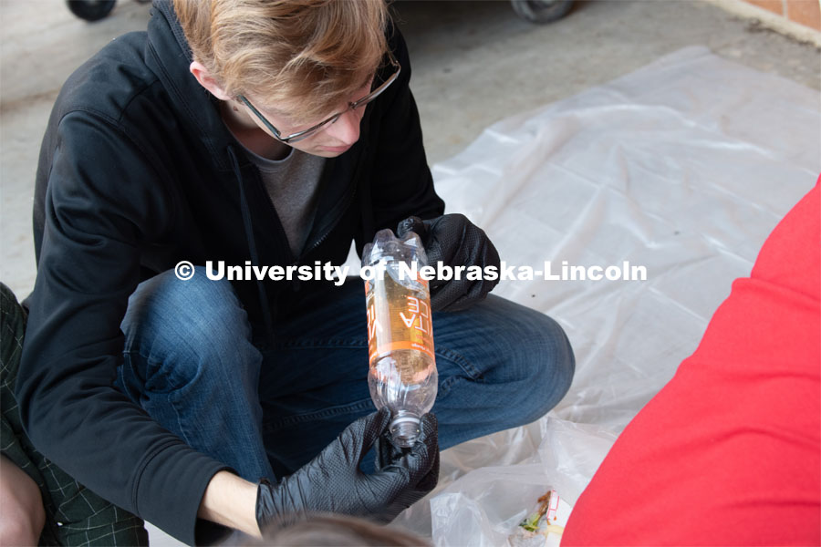 Luke Stursma from the Environmental Studies Orientation class, sorts refuse from lunch at Lincoln Southwest High School. September 25, 2019. Photo by Greg Nathan / University Communication.