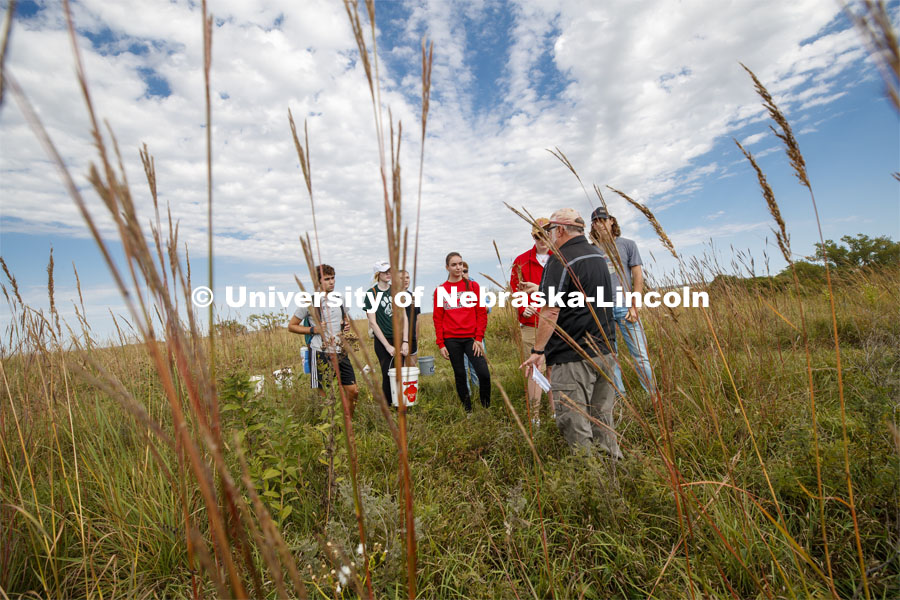 Dave Wedin talks with students. Natural Resources 101 course learns about tall grass plants and range management at Nine Mile Prairie northwest of Lincoln. September 26, 2019. Photo by Craig Chandler / University Communication.