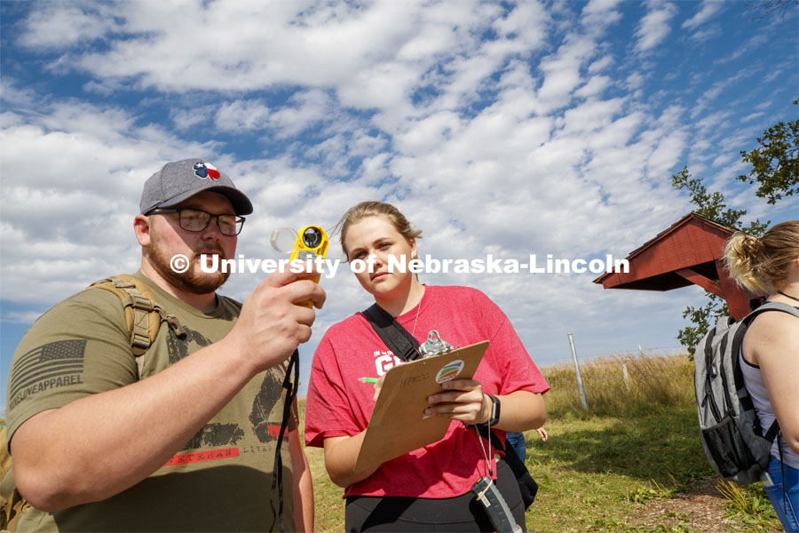 Cody Jones, a senior in fisheries and wildlife from Papillion, NE, and Anna Crist, an undecided sophomore from Aurora, NE, take a wind speed reading at the prairie to determine fire danger levels. Natural Resources 101 course learns about tall grass plants and range management at Nine Mile Prairie northwest of Lincoln. September 26, 2019. Photo by Craig Chandler / University Communication.