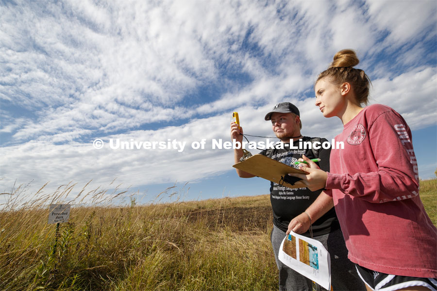 Trent Totusek, a senior in fisheries and wildlife from Papillion, NE, and Emma Wilson, a sophomore in fisheries and wildlife from Chicago, take wind speed readings at the prairie to determine fire danger levels. Natural Resources 101 course learns about tall grass plants and range management at Nine Mile Prairie northwest of Lincoln. September 26, 2019. Photo by Craig Chandler / University Communication.