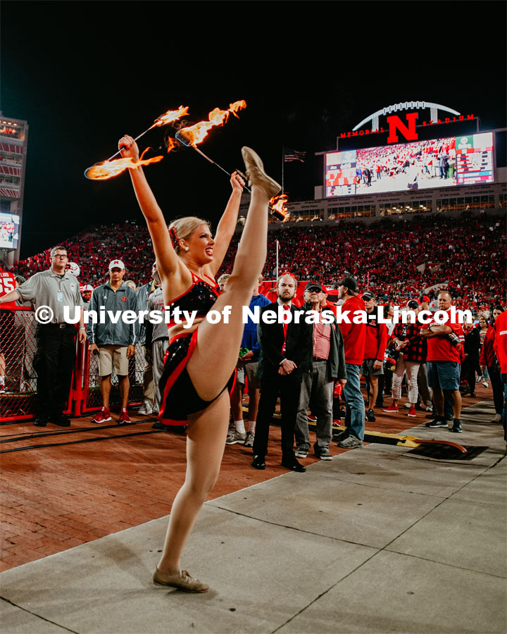 Twirler Carrigan Hurst twirling with batons lit on fire. Nebraska vs. Ohio State University football game. September 28, 2019. Photo by Justin Mohling / University Communication.