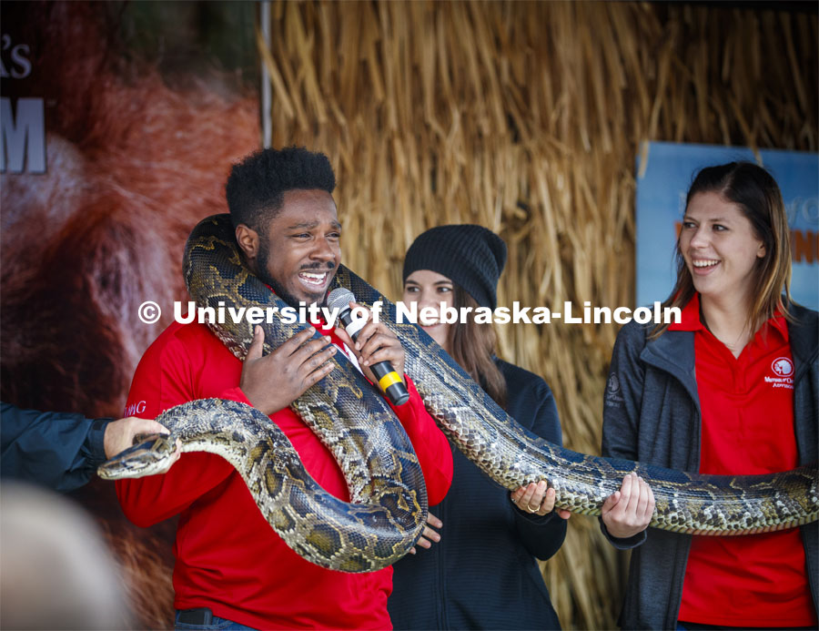 Emcee D-Wayne Taylor makes friends with a boa constrictor at the Mutual of Omaha animal exhibit. Cornstock celebration and Homecoming Parade. October 4, 2019. Photo by Craig Chandler / University Communication.