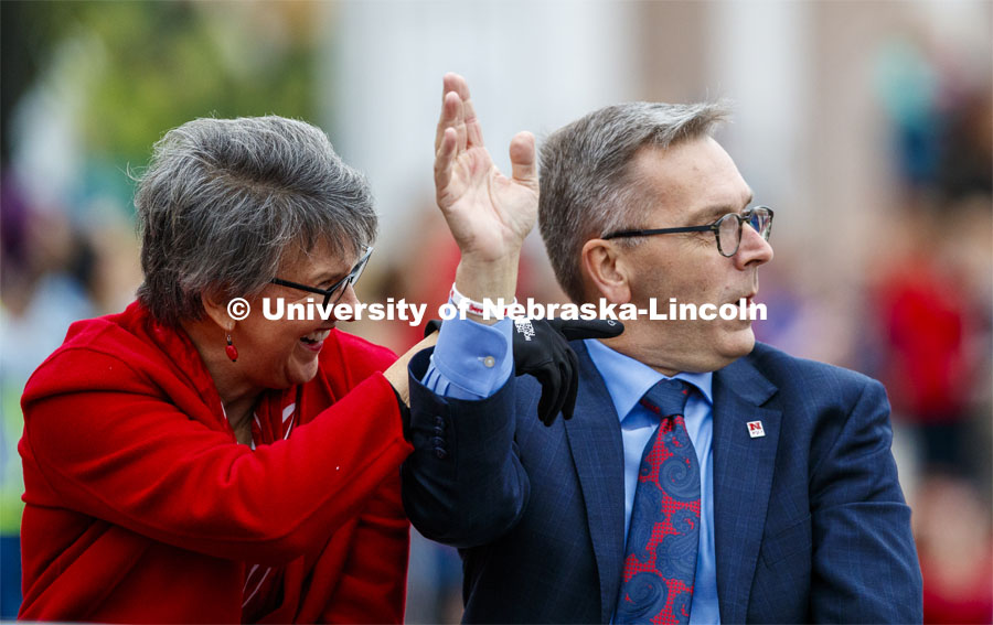 Chancellor Ronnie Green and his wife, Jane, wave to friends as they pass the stadium. Cornstock celebration and Homecoming Parade. October 4, 2019. Photo by Craig Chandler / University Communication.