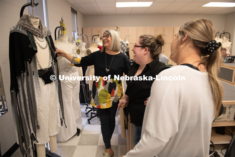 Sandra Starkey (left), assistant professor in Textiles, Merchandising and Fashion Design, looks over a garment made by Heather Striebel (center) in a fashion design class. Textiles, Merchandising and Fashion Design photo shoot. October 24, 2019. Photo by Gregory Nathan / University Communication.
