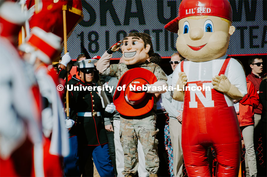 Herbie Husker is decked out in military fatigues and salutes the flag. Lil Red is by his side. Nebraska vs. Indiana University football game. October 26, 2019. Photo by Justin Mohling / University Communication.