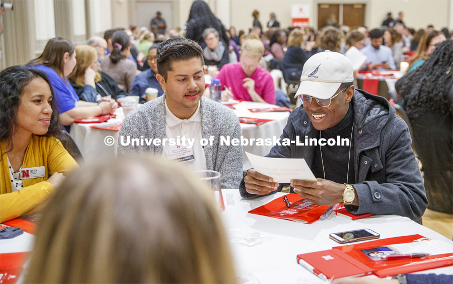 From left: Temi Onayemi, Miguel Avila Garcia, and Emy Kata talk over diversity discussion prompts as part of the State of Diversity summit in the Union Ballroom. October 29, 2019. Photo by Craig Chandler / University Communication.