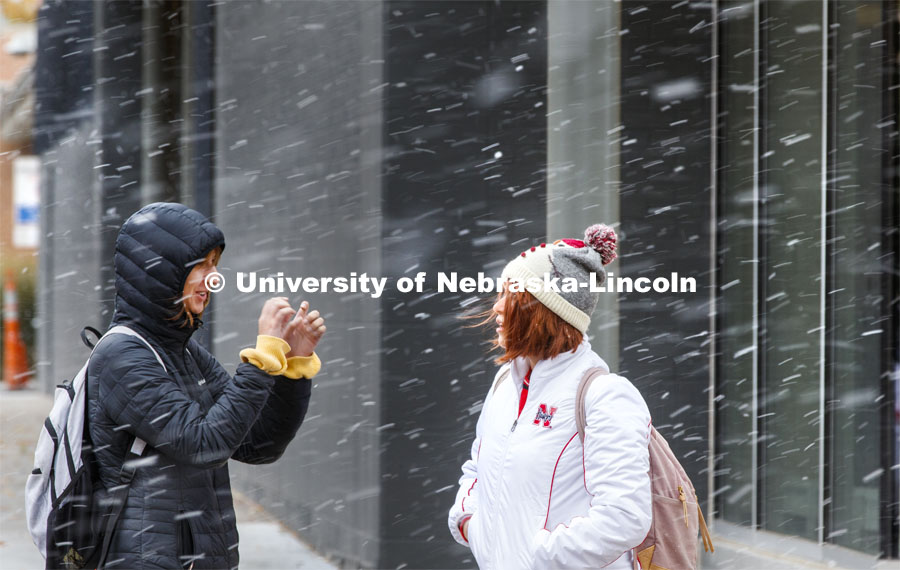 Two young women crossing campus in the snow. Snow on campus. October 30, 2019. Photo by Craig Chandler / University Communication.