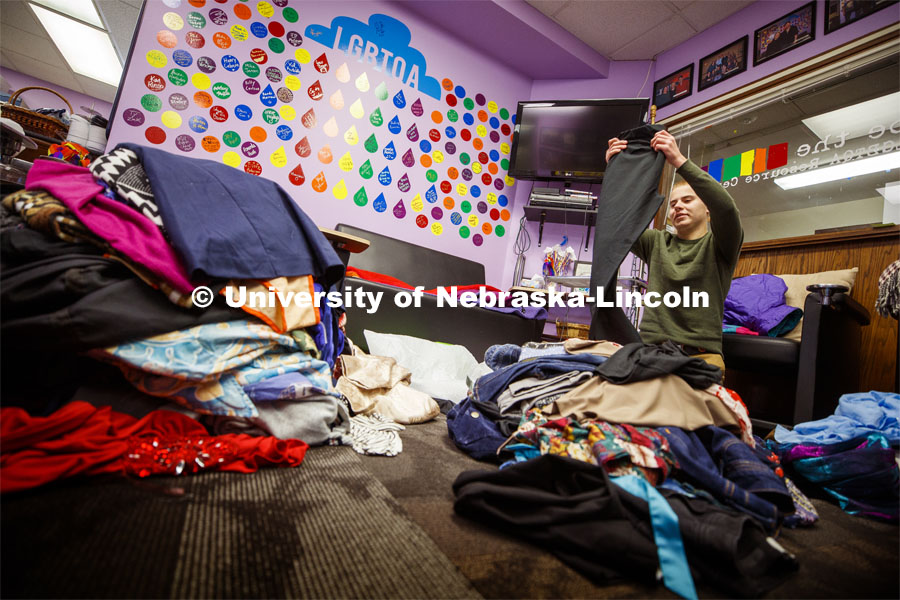 Will Jackson, senior in psychology from Waverly, sorts donations at the resource center. Lavender Closet donations for LGBTQA+ students. November 4, 2019. Photo by Craig Chandler / University Communication.