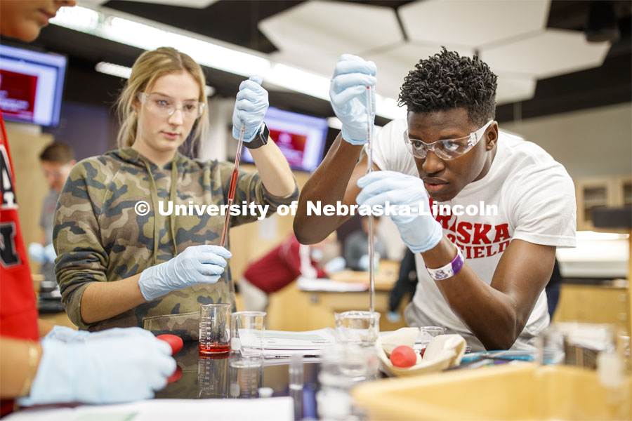 Lily Bruner and Terrol Wilson draw up liquids in a Chem 109 lab to determine absorption spectra and best wavelengths in different food dyes. Chemistry Lab in Hamilton Hall. November 7, 2019. Photo by Craig Chandler / University Communication.