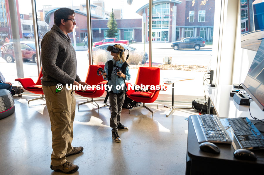 Young boy is being shown how to use the HP Backpack VR set at the Carson dedication ceremony. Johnny Carson Center for Emerging Media Arts dedication weekend. November 17, 2019. Photo by Justin Mohling / University Communication.