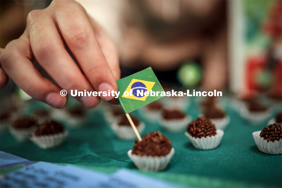 A tiny Brazil flag is inserted into a piece of Brigadeiro, a traditional desert served at every birthday party and made of cocoa powder and condensed milk. Global Huskers Festival, a multicultural festival provides attendees the chance to explore the world through informational booths that will have food, cultural décor, art, and more, each hosted by UNL students from those culture. November 19, 2019. Photo by Craig Chandler / University Communication.