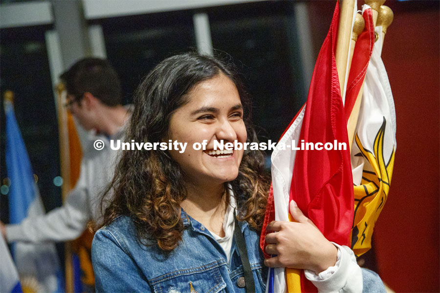 Cristal Franco holds an armful of flags being setup for display at the festival. Global Huskers Festival, a multicultural festival provides attendees the chance to explore the world through informational booths that will have food, cultural décor, art, and more, each hosted by UNL students from those culture. November 19, 2019. Photo by Craig Chandler / University Communication.