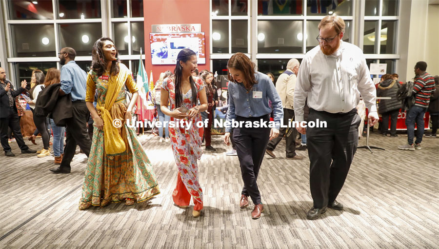 Anh Le, second from left, shows Naisargee Patel, Cait Naberhaus and Connor Willingham how to Samba line dance. Global Huskers Festival, a multicultural festival provides attendees the chance to explore the world through informational booths that will have food, cultural décor, art, and more, each hosted by UNL students from those culture. November 19, 2019. Photo by Craig Chandler / University Communication.