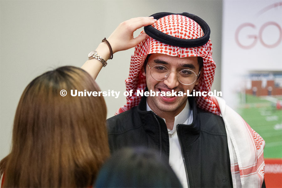 Abraham Al-Quasen, an international student from Saudi Arabia, has his headdress adjusted at the festival. Global Huskers Festival, a multicultural festival provides attendees the chance to explore the world through informational booths that will have food, cultural décor, art, and more, each hosted by UNL students from those culture. November 19, 2019. Photo by Craig Chandler / University Communication.