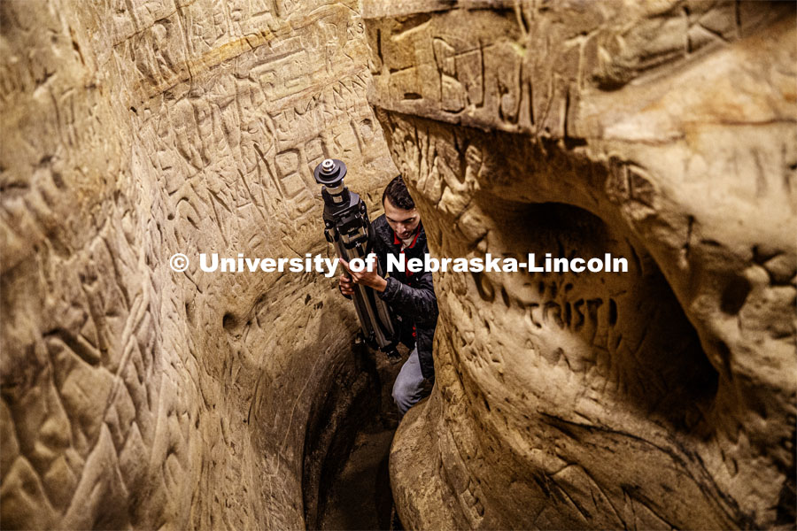Dylan Downes, a sophomore in civil engineering from Lincoln, carries the tripod through a passage after mapping part of the cave. Professor Ricky Wood uses LIDAR to digitally map Robbers Cave in Lincoln. November 22, 2019. Photo by Craig Chandler / University Communication.