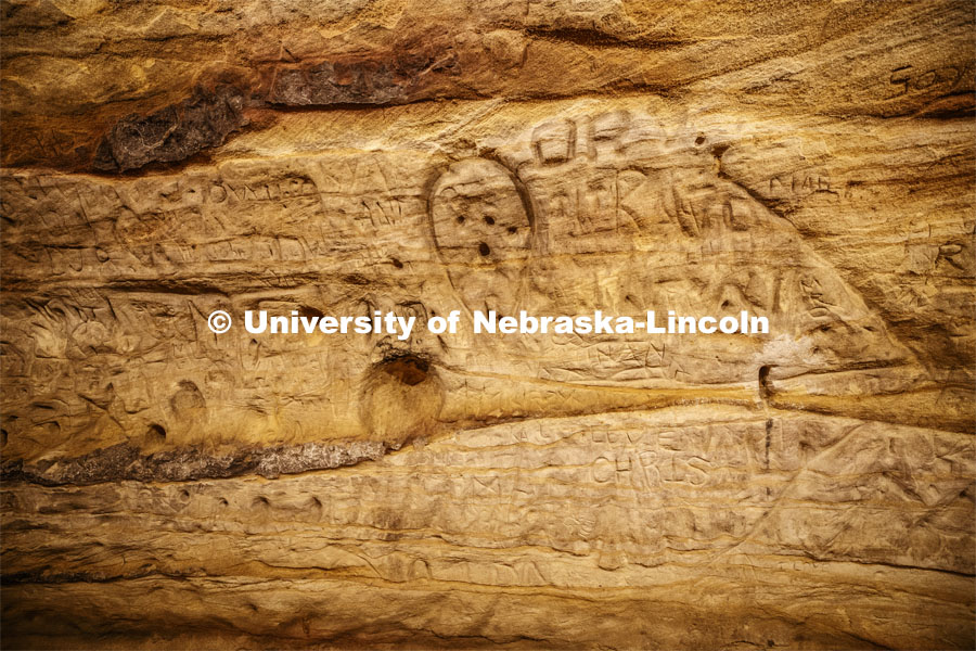Names and drawings fill the walls of the cave. Professor Ricky Wood uses LIDAR to digitally map Robbers Cave in Lincoln. November 22, 2019. Photo by Craig Chandler / University Communication.