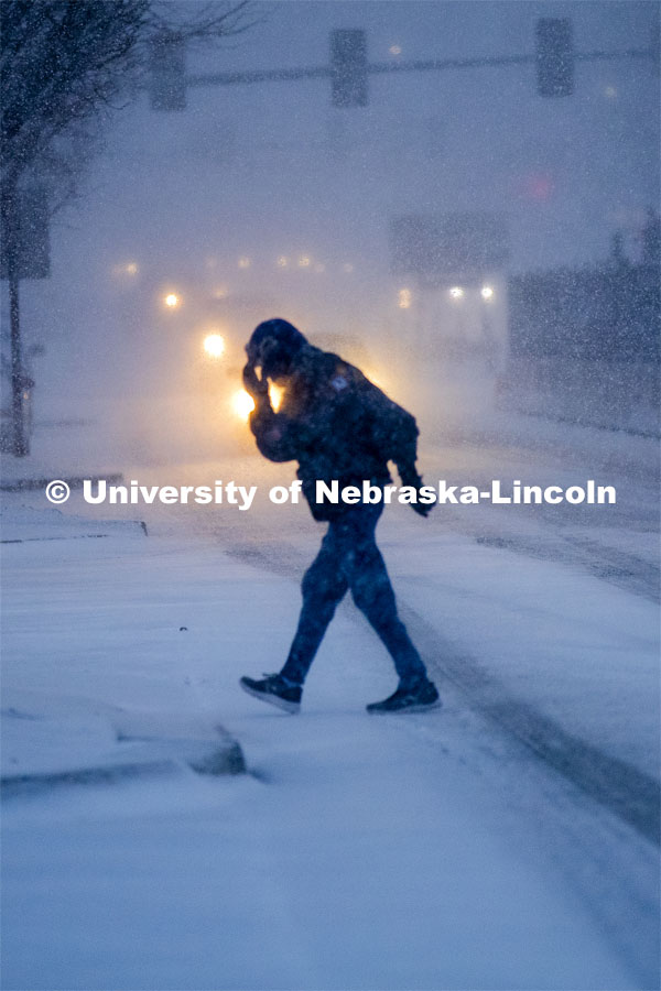 Some Mondays are more Monday than others. Monday morning snowstorm. Person crossing the street in a snow storm. December 9, 2019. Photo by Craig Chandler / University Communication.