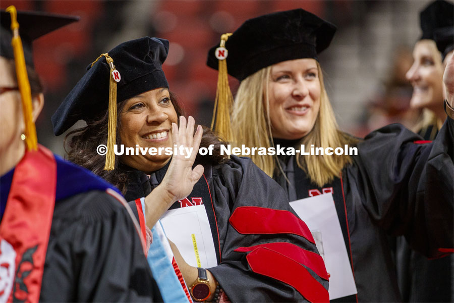Brandi Bibins-Redburn waves to family and friends as she enters the arena. Graduate Commencement and Hooding at the Pinnacle Bank Arena. December 20, 2019. Photo by Craig Chandler / University Communication.