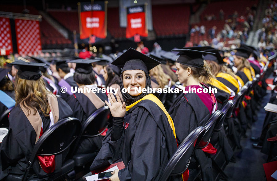 Sedighe Keynia waves to family and friends at the Graduate Commencement and Hooding at the Pinnacle Bank Arena. December 20, 2019. Photo by Craig Chandler / University Communication.