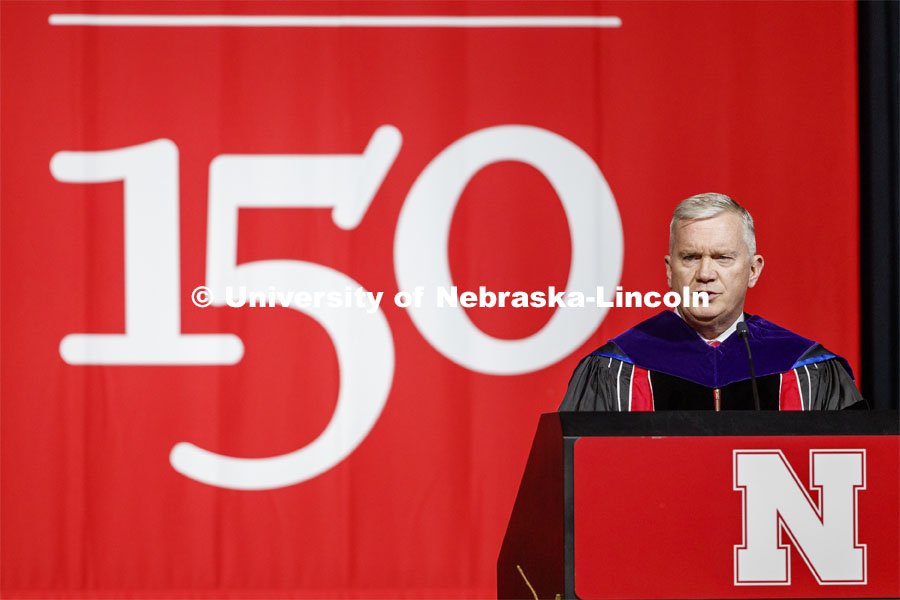 Regent Tim Clare gives remarks on the final N150 commencement weekend of the anniversary year. Graduate Commencement and Hooding at the Pinnacle Bank Arena. December 20, 2019. Photo by Craig Chandler / University Communication.