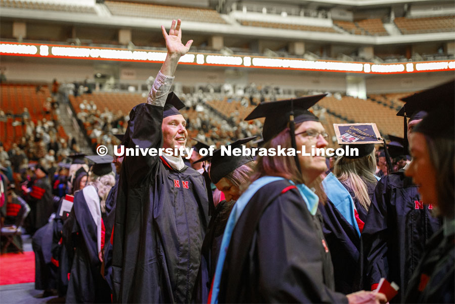 Phillip Carter waves to family at the Graduate Commencement and Hooding at the Pinnacle Bank Arena. December 20, 2019. Photo by Craig Chandler / University Communication.