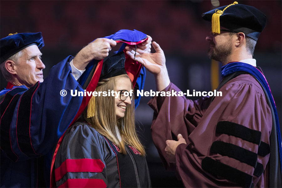 Victoria Donovan has her hood placed over her head at the Graduate Commencement and Hooding at the Pinnacle Bank Arena. December 20, 2019. Photo by Craig Chandler / University Communication.