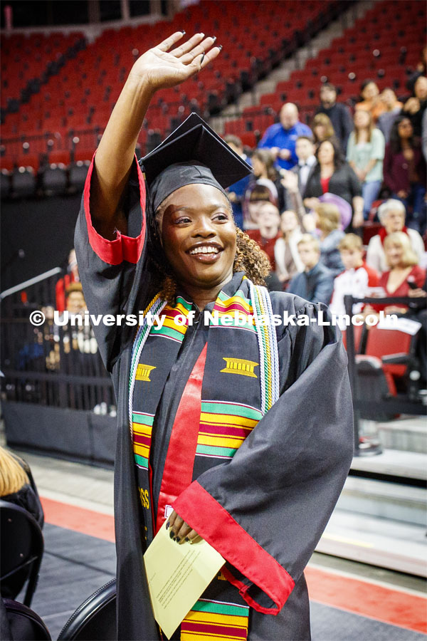 Aleece Barnard waves to family and friends as she enters the arena. December Undergraduate commencement at Pinnacle Bank Arena. December 21, 2019. Photo by Craig Chandler / University Communication.