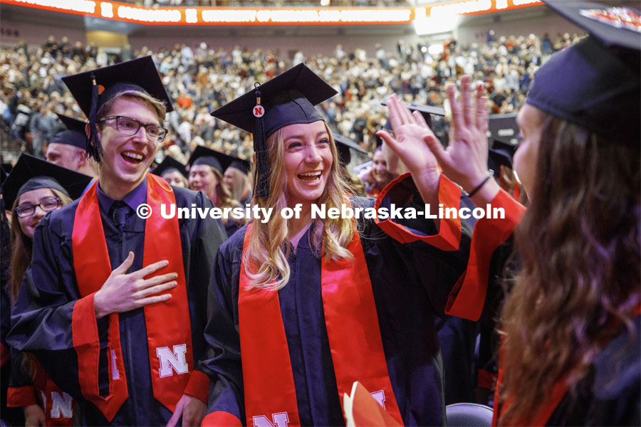 From right; Chase Nissen, Kristen Nett, and Danielle Nelson celebrate their graduation as part of Regent Clare's greeting to the students. December Undergraduate commencement at Pinnacle Bank Arena. December 21, 2019. Photo by Craig Chandler / University Communication.