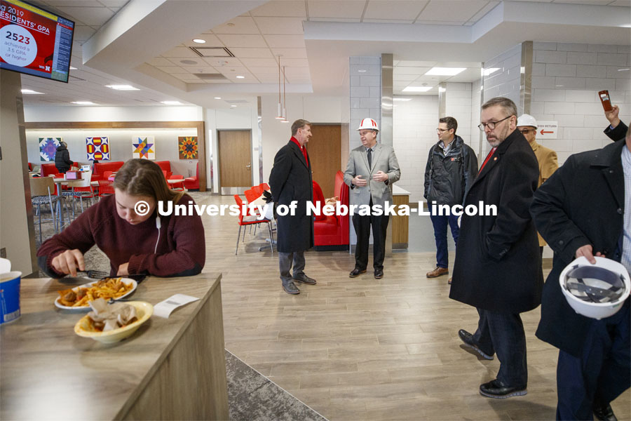 Ryan Lahne, interim director of the east campus union, (at center, wearing hard hat) discusses the new east campus dining center during the tour. NU President Ted Carter tours UNL campuses. January 16, 2020. Photo by Craig Chandler / University Communication.