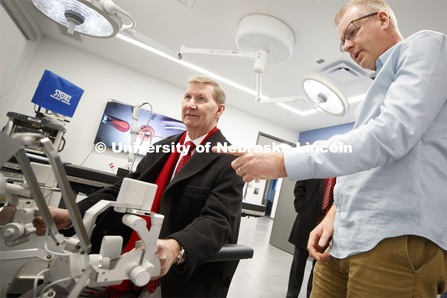 NU President Ted Carter tries out Shane Farritors's surgery robot.  President Carter manipulated the robot to move foam tubes over small pegs. (seen over his right shoulder) Farritor is a Professor of Mechanical and Materials Engineering and founder of Virtual Incision which is housed at NIC's RISE building. NU President Ted Carter tours UNL campuses. January 16, 2020. Photo by Craig Chandler / University Communication.