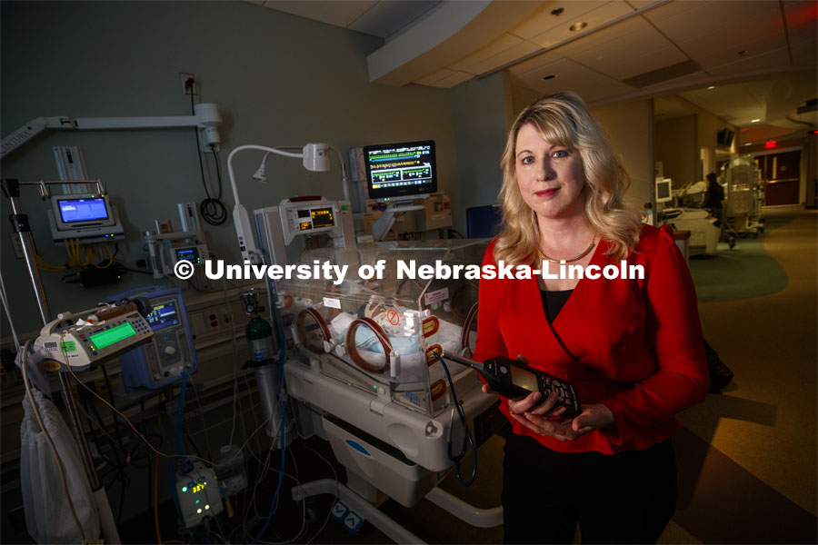 Erica Ryherd holds an acoustic meter while checking levels in the room of Ah'Mel, a patient at Nebraska Med’s Newborn Intensive Care Unit. Ah'Mel was born November 29, 2019 with a birth weight of 1.68 pounds. Ryherd, an Associate Professor in The Durham School of Architectural Engineering and Construction, is making neonatal intensive care units better for their young patients. She specializes in noise control, architectural acoustics, environmental noise, and human response to the built environment. January 23, 2020. Photo by Craig Chandler / University Communication.