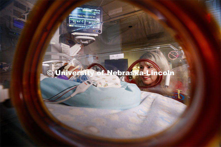 Erica Ryherd looks in on Ah'Mel, a patient at Nebraska Med’s Newborn Intensive Care Unit. Ah'Mel was born November 29, 2019 with a birth weight of 1.68 pounds. Ryherd, an Associate Professor in The Durham School of Architectural Engineering and Construction, is making neonatal intensive care units better for their young patients. She specializes in noise control, architectural acoustics, environmental noise, and human response to the built environment. January 23, 2020. Photo by Craig Chandler / University Communication.