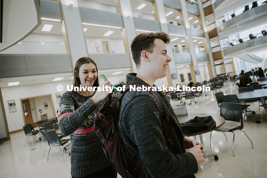 Erika Swenson a junior in wildlife and fisheries management with ASUN ties a green bandana on Justin Myers backpack. The bandanas are being given out to promote mental health awareness on campus. January 29, 2020. Photo by Craig Chandler / University Communication.