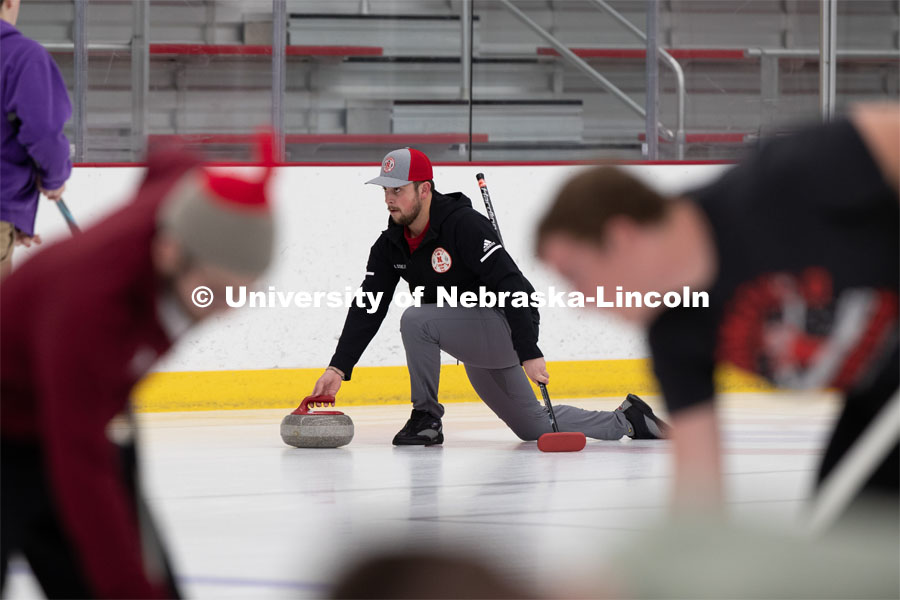 Colin Wooldrik of the UNL Curling Team throws a curling stone at the John Breslow Ice Arena. Nebraska's nationally-ranked curling club host its first bonspiel at the John Breslow Ice Hockey Center this weekend. The bonspiel — or tournament — featured seven traveling schools from across the Midwest. February 1, 2020. Photo by Gregory Nathan / University Communication.