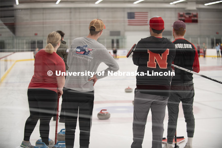 Left to right Anna Fiala, Jordan Monk, Adam Schlichtmann and Colin Wooldrik of the UNL Curling Team watch in anticipation as their competitors stone travels down the ice. Nebraska's nationally-ranked curling club host its first bonspiel at the John Breslow Ice Hockey Center this weekend. The bonspiel — or tournament — featured seven traveling schools from across the Midwest. February 1, 2020. Photo by Gregory Nathan / University Communication.