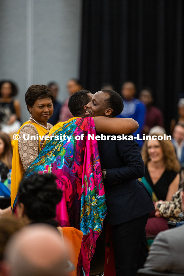 A student embraces a member of Mathilde Mukantabana’s team at the University of Nebraska–Lincoln's Rwanda Night celebration in the Nebraska Union's Centennial Room. The annual event feature Rwandan-inspired cuisine, dancing and traditional music. February 1, 2020. Photo by Justin Mohling / University Communication.