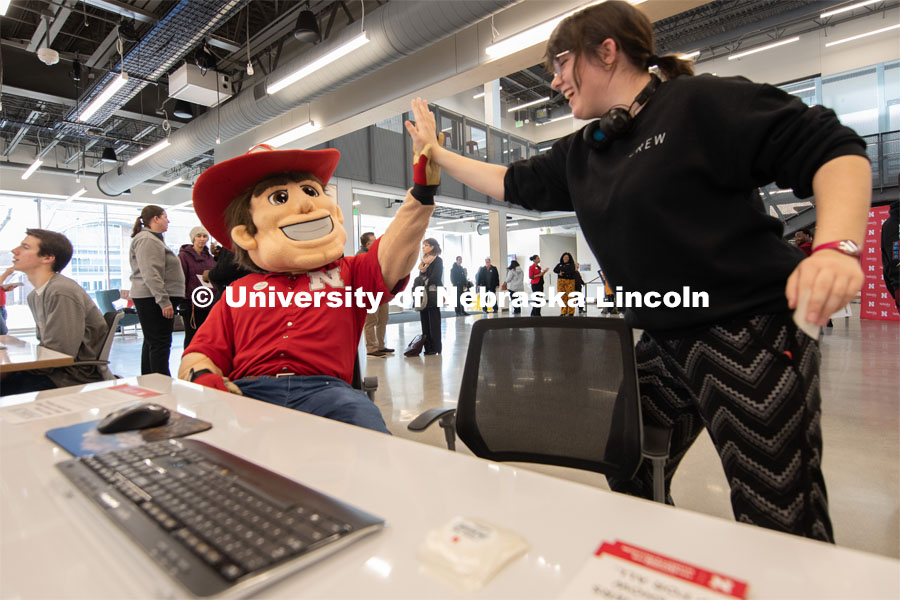 Herbie gets a high-five from a student after they fill out the CEO Action Diversity and Inclusion Pledge at the Johnny Carson Center for Emerging Media Arts. February 5, 2020. Gregory Nathan / University Communication.