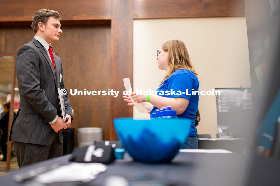 Ben Chaloupka talking with a representative of Nelnet. Employers are able to talk with students about possible employment at the Spring University Career Fair in the Nebraska Union. February 11, 2020. Photo by Justin Mohling / University Communication.