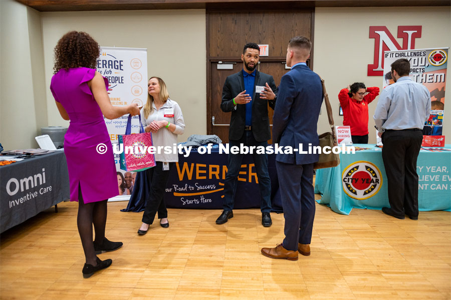 Students talking with Werner Enterprises representatives. Employers are able to talk with students about possible employment at the Spring University Career Fair in the Nebraska Union. February 11, 2020. Photo by Justin Mohling / University Communication.
