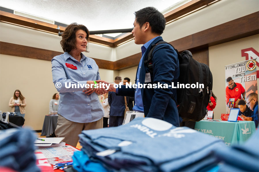 UNL Student Aria Wisnu Tarudji shakes hands with Alum Kara Asumus after speaking about Columbus Area Chamber of Commerce. Employers are able to talk with students about possible employment at the Spring University Career Fair in the Nebraska Union. February 11, 2020. Photo by Justin Mohling / University Communication.
