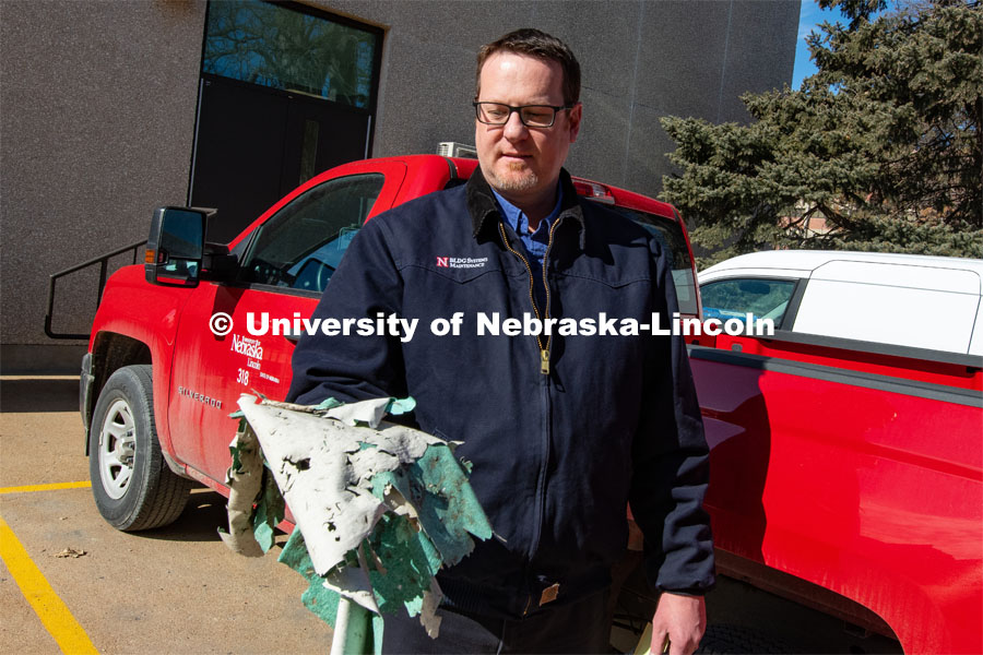 Berry Scott, Zone Preventive Maintenance Lead of FM&P Building Systems Maintenance, holds material found in the parking lot of the Sheldon. He and his team will use drones to inspect and take pictures of the rooftops of city campus buildings. February 18, 2020. Photo by Gregory Nathan / University Communication.