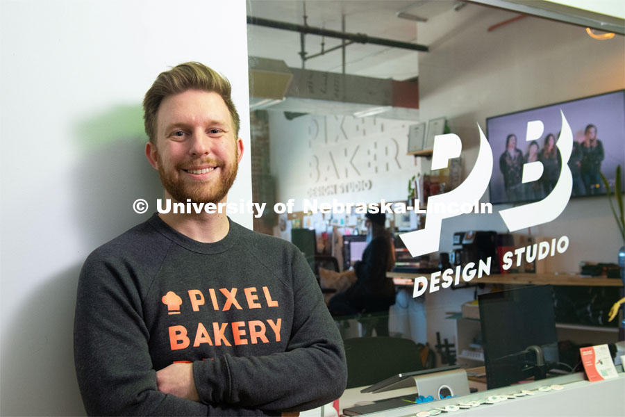 Nebraska alum Jordan Lambrecht stands outside Pixel Bakery Design Studio, which he co-founded in 2015. Lambrecht started the business with two classmates he met in Jacht, the University of Nebraska–Lincoln's student-run advertising agency. February 20, 2020. Photo by Greg Nathan / University Communication.