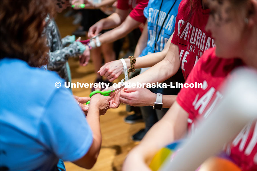 Students getting their symbolic wristbands cut off by miracle children. University of Nebraska–Lincoln students exceeded their goal, raising $235,229 during the annual HuskerThon on Feb. 29. Also known as Dance Marathon, the event is part of a nationwide fundraiser supporting Children’s Miracle Network Hospitals. The annual event, which launched in 2006, is the largest student philanthropic event on campus. The mission of the event encourages participants to, “dance for those who can’t.” All funds collected by the Huskers benefit the Children’s Hospital and Medical Center in Omaha. February 29, 2020. Photo by Justin Mohling / University Communication.