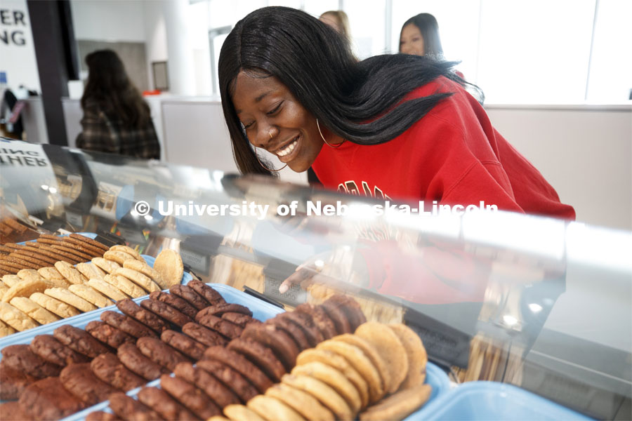 Cather Dining Center photoshoot. A young woman choosing a cookie. March 2, 2020 Photo by Craig Chandler / University Communication.