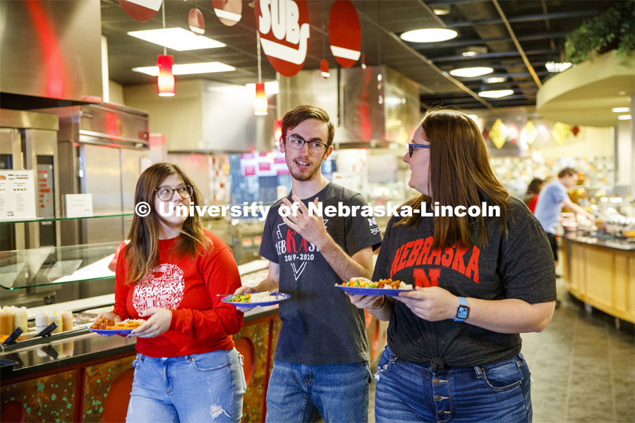 Harper Dining Center photo shoot. Students visit while looking for a place to sit at Harper Dining Center. March 3, 2020. Photo by Craig Chandler / University Communication.