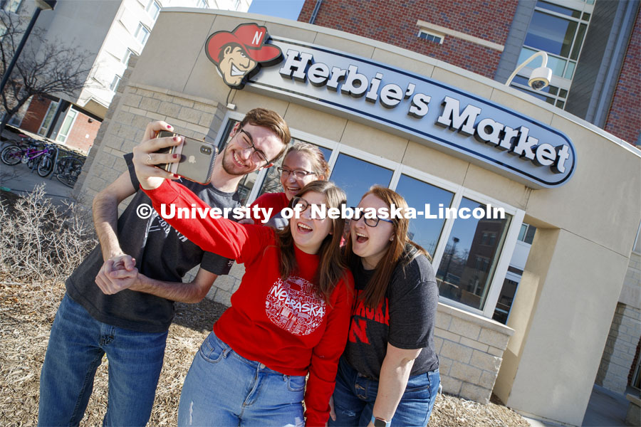 Harper Dining Center photo shoot. Students snap a selfie outside Herbie’s Market near Harper Dining Center. March 3, 2020. Photo by Craig Chandler / University Communication.