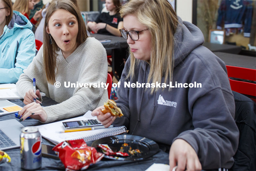 Emily Reitz, sophomore in Agricultural Education from Eaton, Colorado, reacts as she and Maggie Vyhnalek - a sophomore in Agricultural Education from Friend, NE, work on a quiz while eating. Lunch In The Lobby in the Animal Science building lobby is part of CASNR week. March 11, 2020. Photo by Craig Chandler / University Communication.