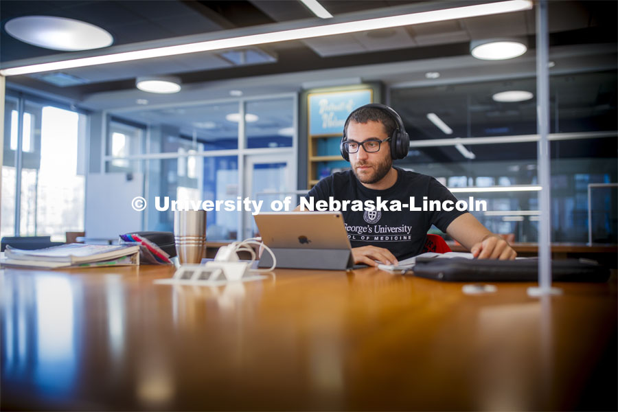 Ramsey Jaber, a 2015 UNL alumni, studies his medical texts in Love Library Tuesday. He is a student of St. George's University school of medicine in Granada and moved back to Lincoln when they closed their campus. City Campus. March 17, 2020. Photo by Craig Chandler / University Communication.