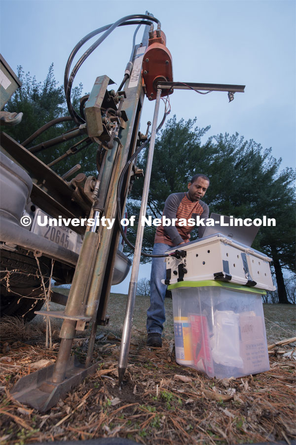 Nuwan Wijewardane, postdoctoral researcher in biological systems engineering, prepares to gather data from multiple locations by hydraulically plunging a penetrometer prototype into soil which is mounted to a Giddings probe truck. March 18, 2020. Photo by Gregory Nathan / University Communication.